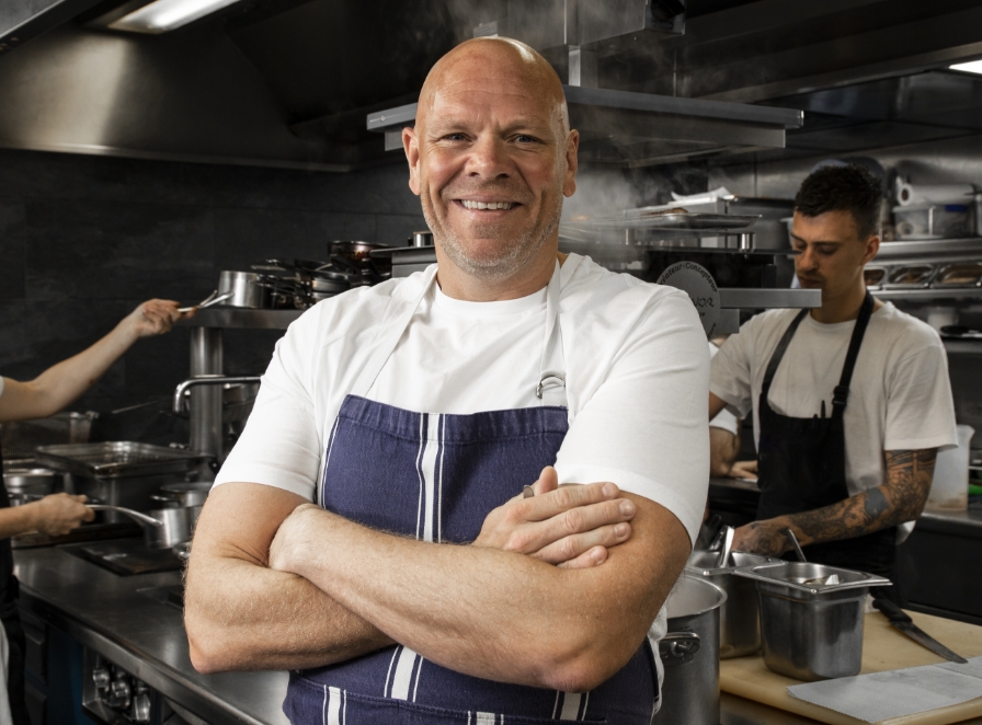 Tom Kerridge posing for a photo in the kitchen